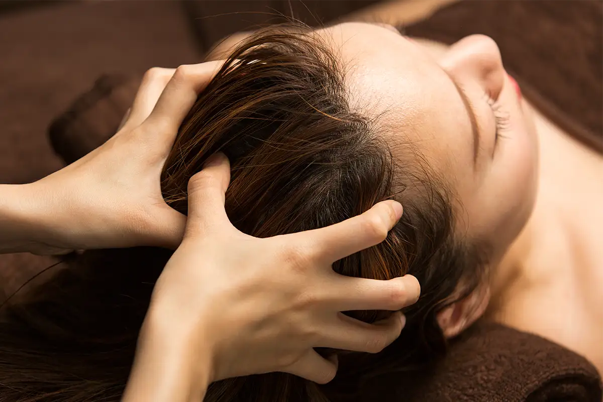 Woman getting a scalp massage