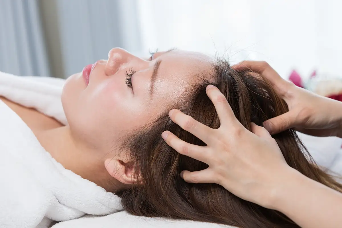 Woman relaxing and getting a scalp massage