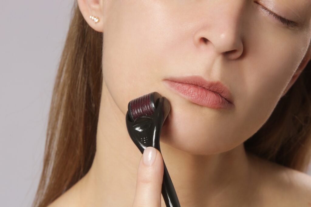 Hand-held facial roller gently gliding over skin during a personal skincare routine in Cape Coral.