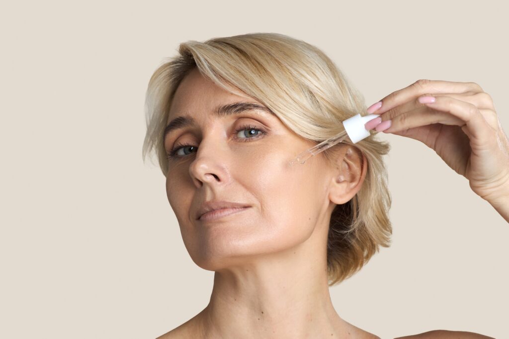 Women using anti-aging facial treatment to reduce wrinkles and improve texture of skin.
