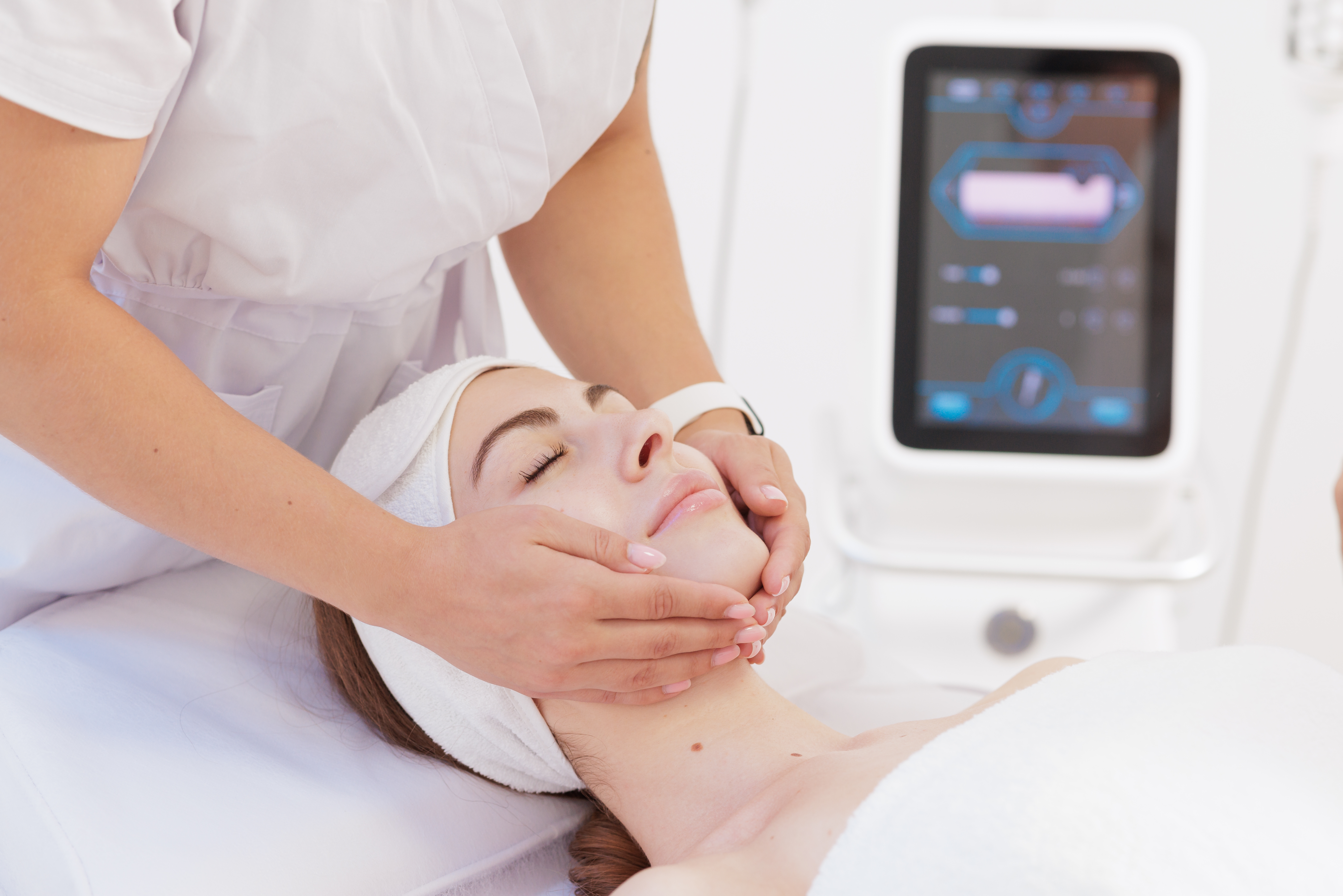 Client receiving a professional facial treatment designed to promote glowing, healthy skin.
