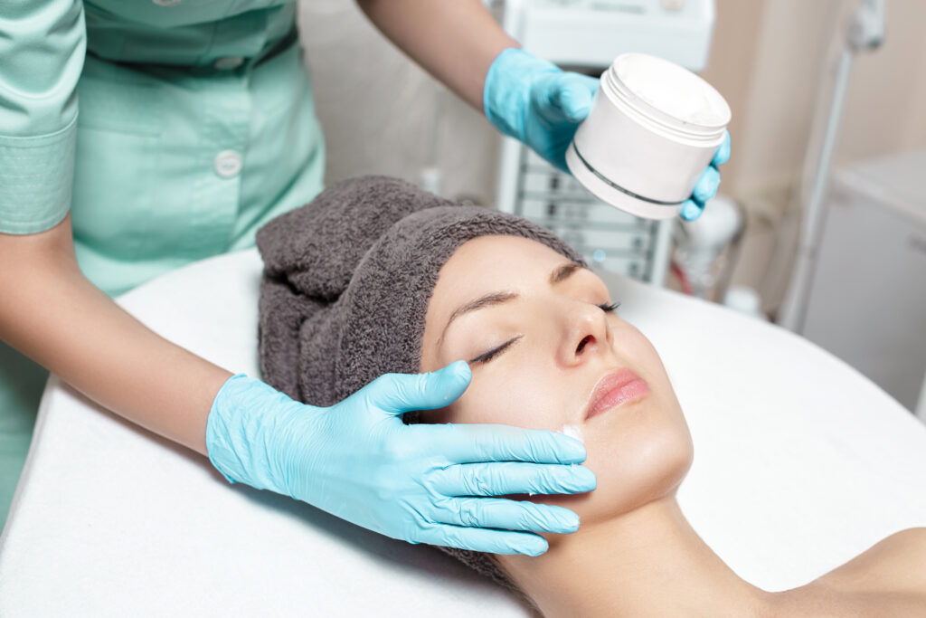 Client receiving a professional facial treatment designed to hydrate and improve skin texture in a spa setting.