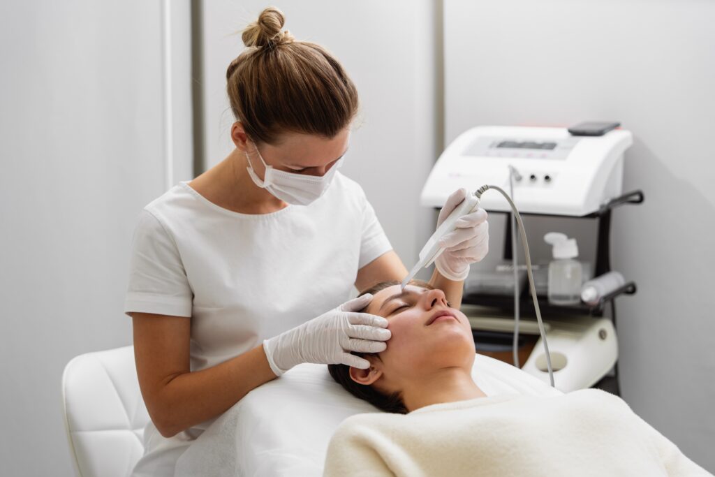 Esthetician performing a professional facial designed to support collagen stimulation and improve skin texture.