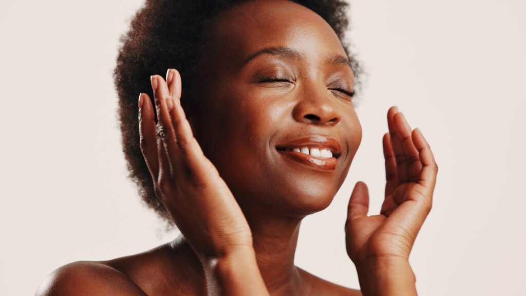 Woman applying gentle exfoliating skincare product while following a simple routine for smoother, healthier looking skin.